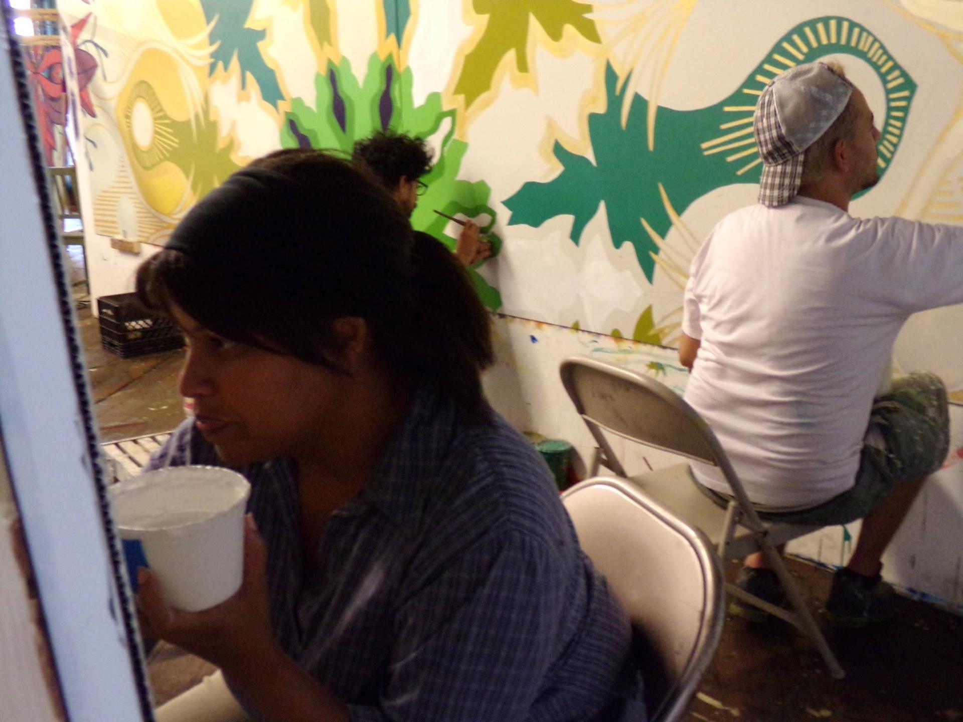 Artists painting colorful mural panels in the studio for the Spring Garden Bridge installation